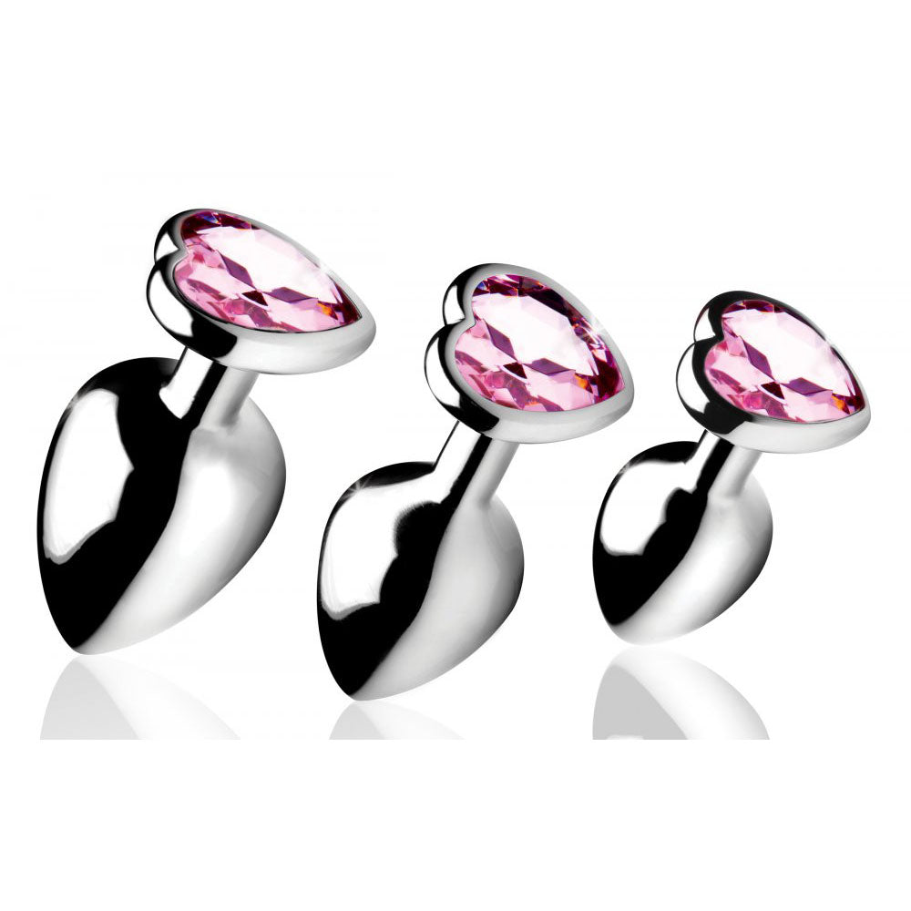 Pink Heart Gem Teardrop Metal Anal Training Set with three silver-tone plugs angled to show their faceted bases.