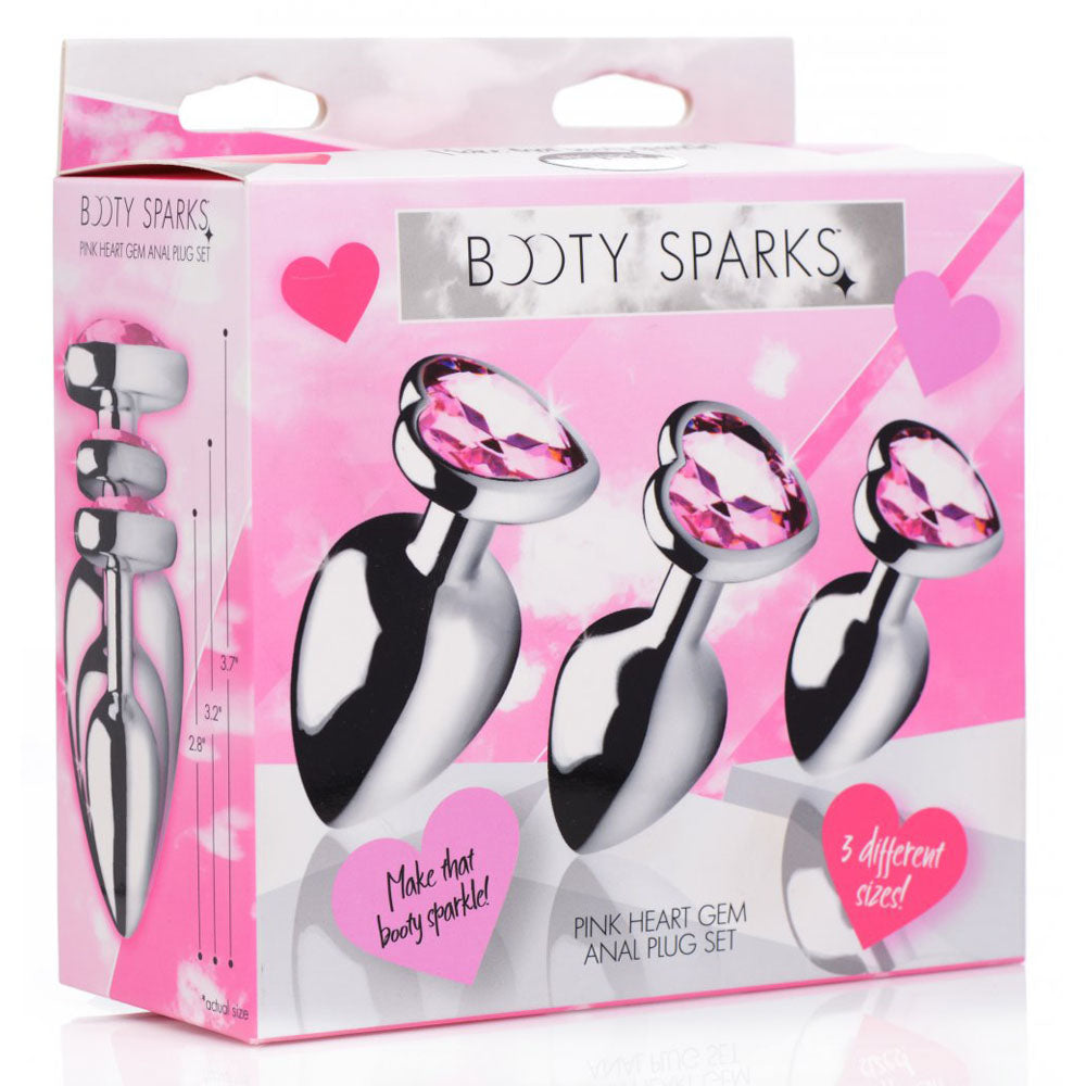 Retail box showing artwork of three silver-tone plugs with pink heart gem bases.