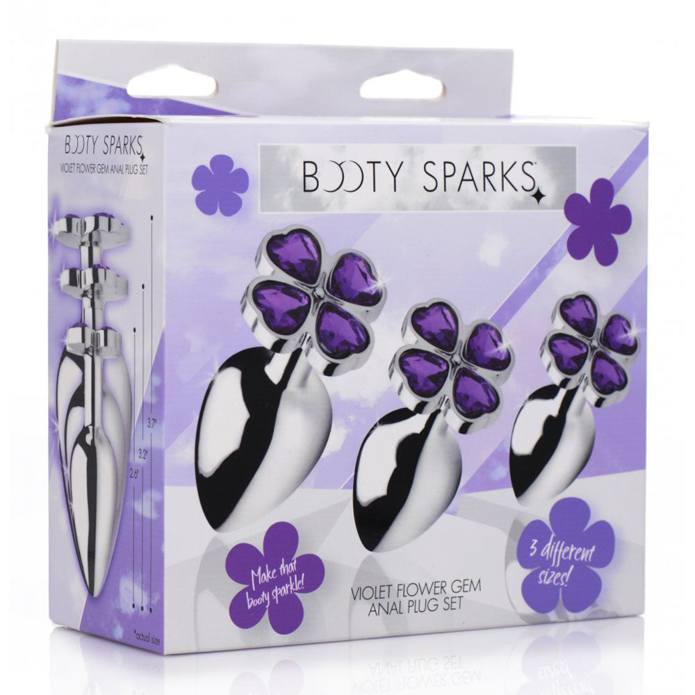 Retail box showing three graduated polished plugs with purple flower-base artwork.