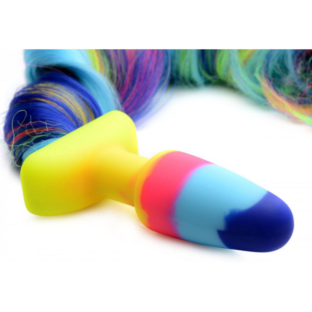 Close-up of the yellow flared base, tapered multicolor silicone plug, and attached rainbow tail