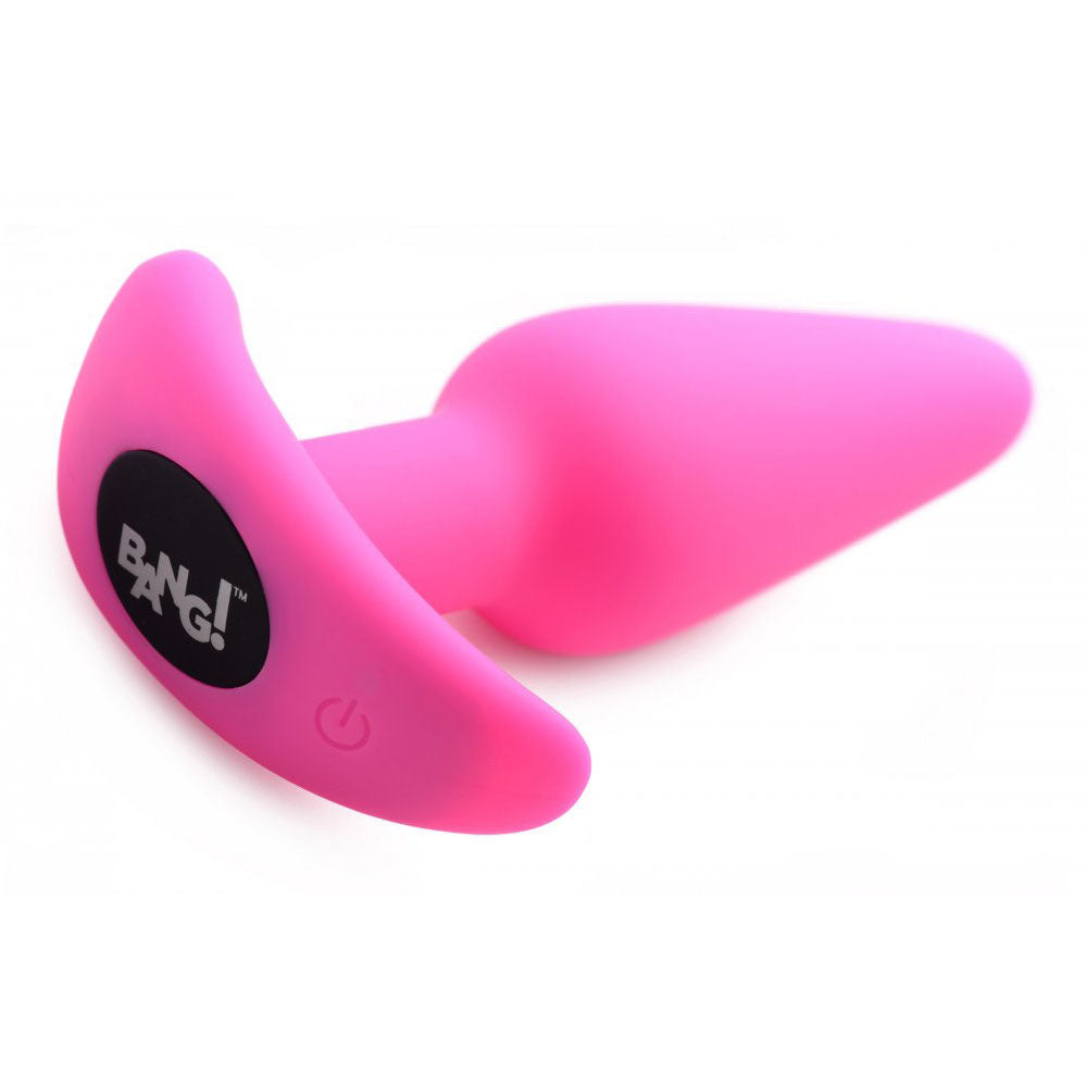 Pink silicone plug angled to show the flared base and power button.
