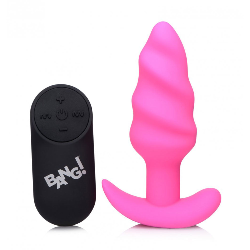 Upright pink swirl butt plug beside a black wireless remote on a white background.