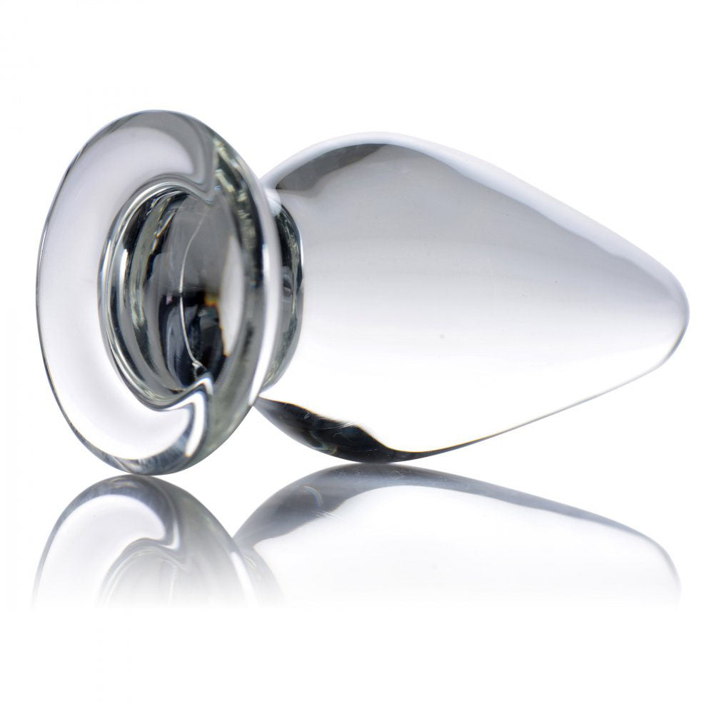 Clear teardrop glass plug lying on its side with round flared base.