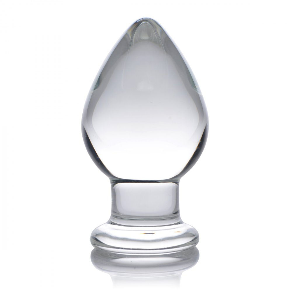 Upright clear glass butt plug with a rounded tapered tip, narrow neck, and wide flared base.