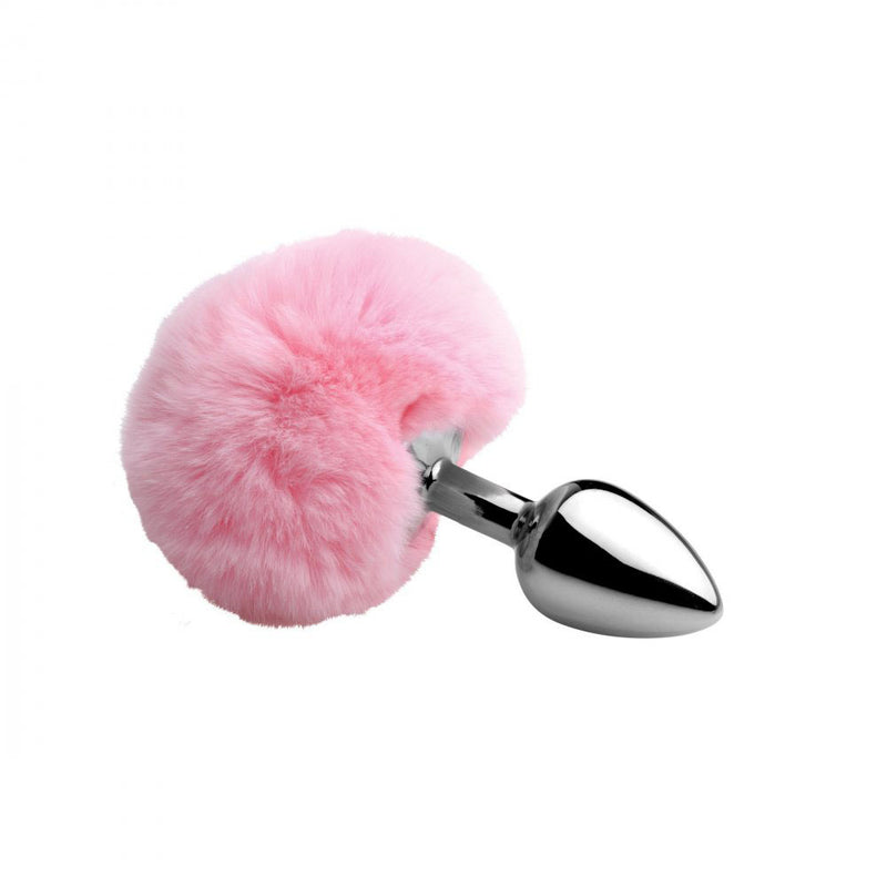 Fluffy pink round tail attached to a polished silver-colored tapered plug on a white background.