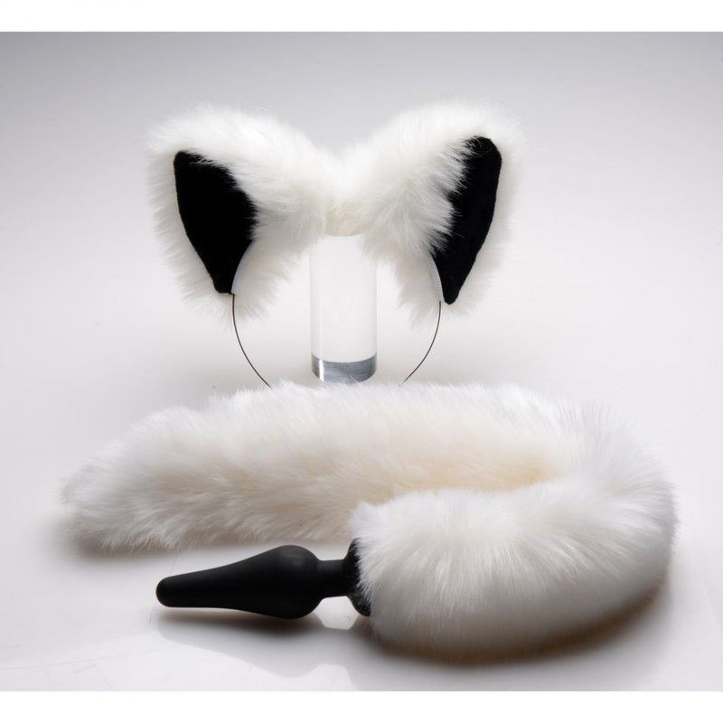 White furry tail attached to a black tapered plug, beside white ears with black inner panels on a headband.
