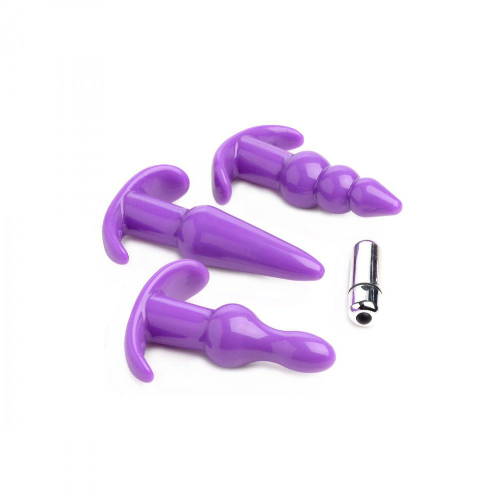 Purple TPR anal plug set laid flat with three shapes and a removable silver bullet