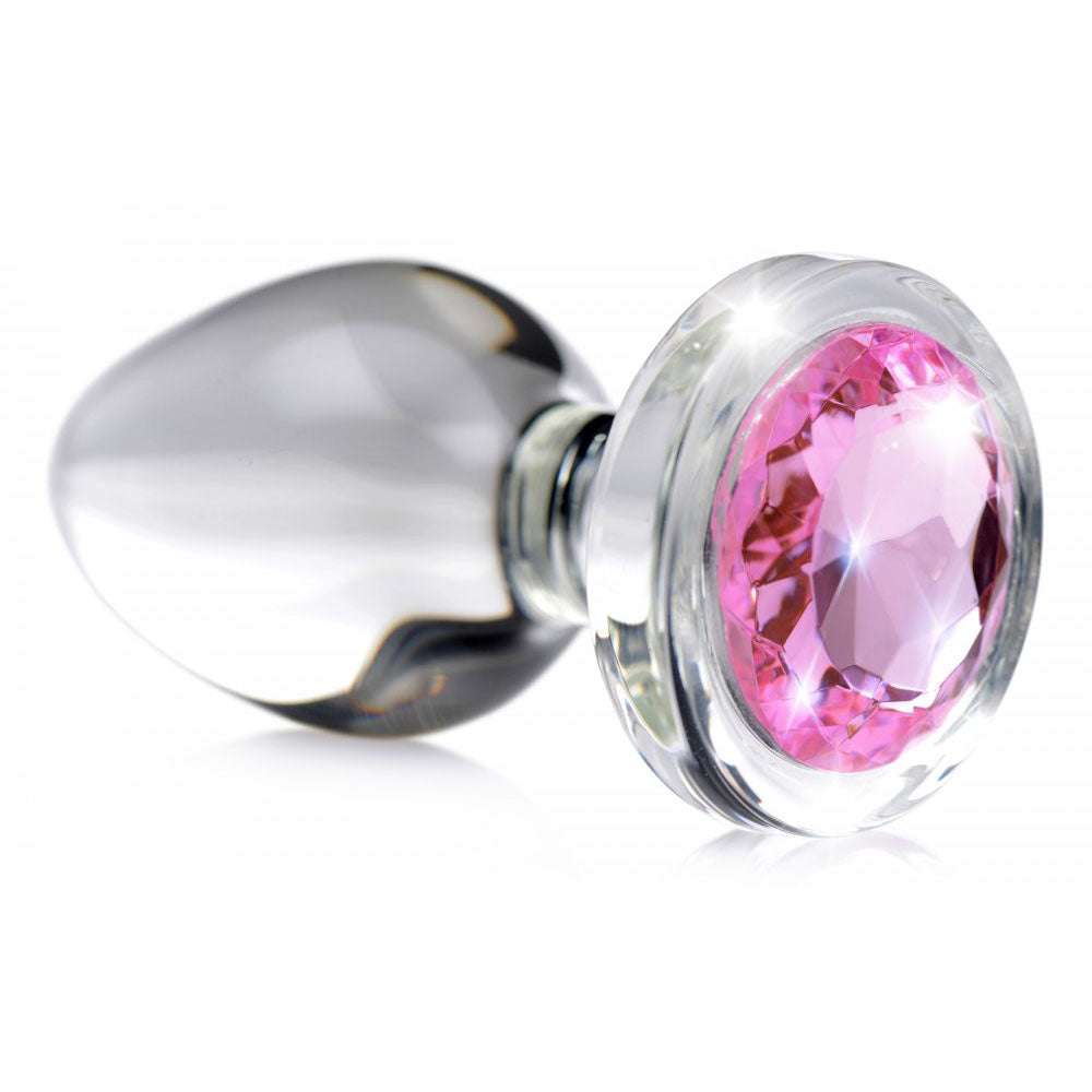 Close-up of clear tapered glass plug with faceted pink jeweled stopper