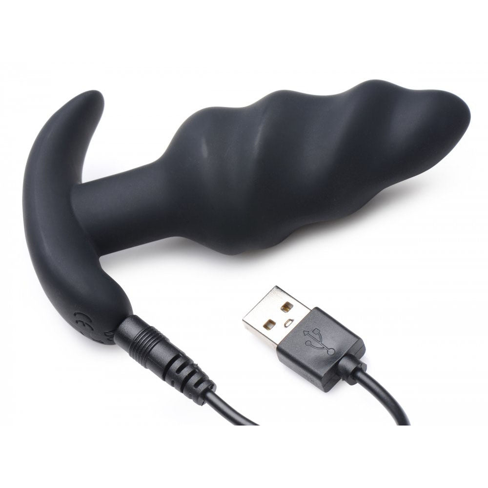 Black silicone swirl plug connected to a USB charging cable.